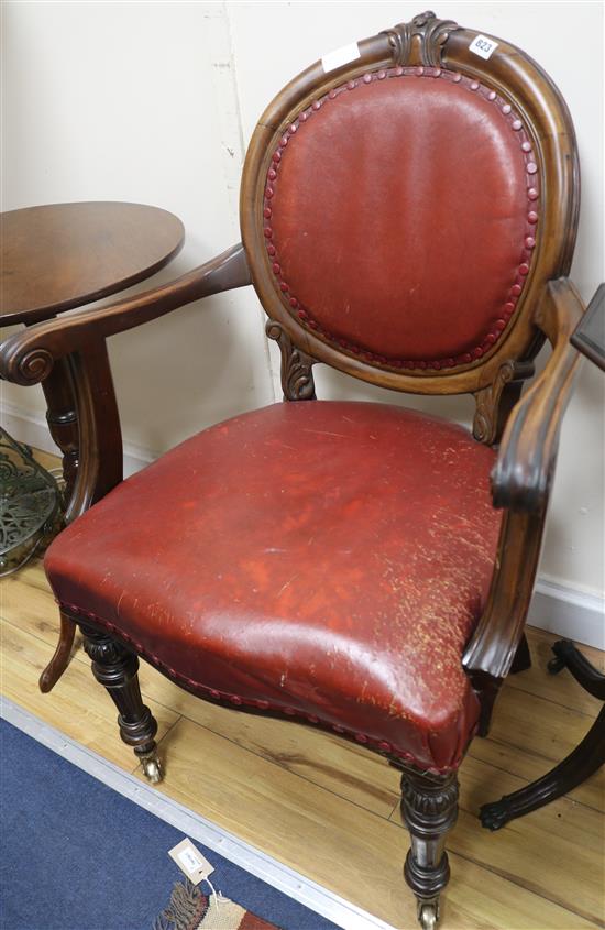 A Victorian red leather elbow chair